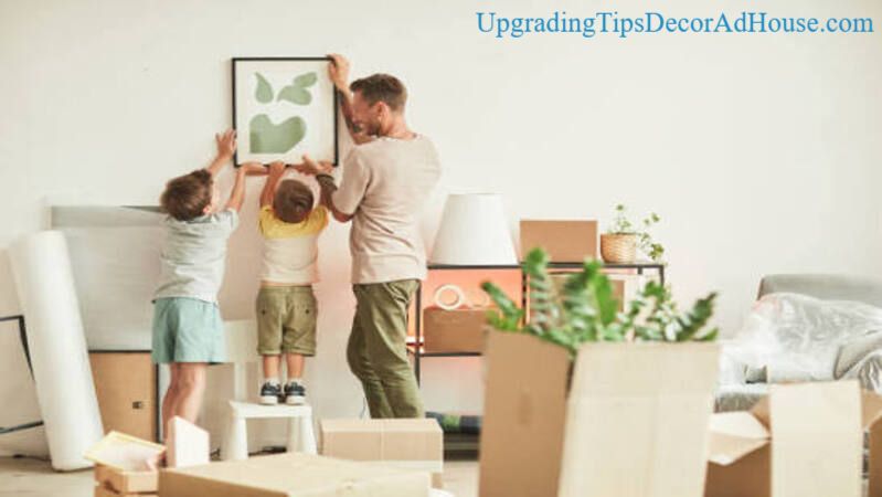 Father and two sons hanging wall art together, Upgrading Tips DecorAdHouse family decorating